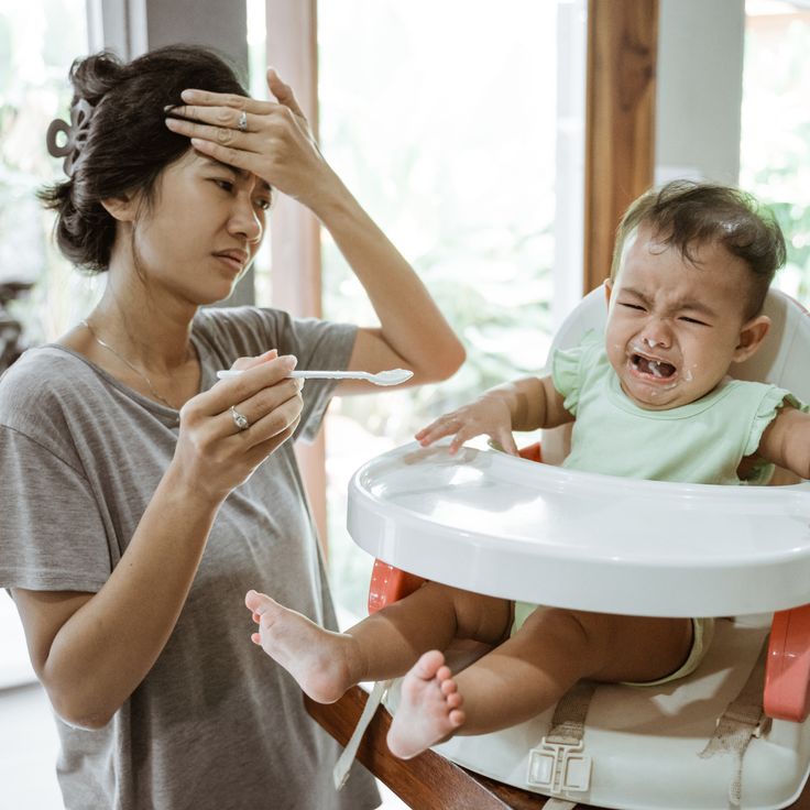 Toddler pushing spoon away in anger